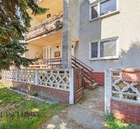 A family house in Topoľníky with a terrace, garden fence, and access walkway.