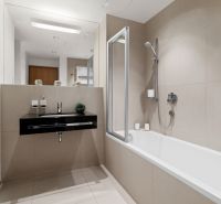 A bathroom in a 2-room apartment with a bathtub, sink, and separate faucet.
