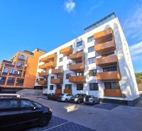 Apartment building on Trnavská Street in Bratislava - Ružinov with parking spaces in front of it.