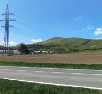 Landscape on Továrenská in Smolenice with agricultural and forest lands and power lines.
