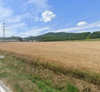 Agricultural and forest land on Továrenská Street in Smolenice with a view of the hills.