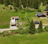 Residential plots in Rajecká Lesná surrounded by greenery and coniferous forests.
