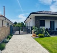 A family house on Jasná Street in Veľké Dvorníky with a landscaped garden and an entrance gate.