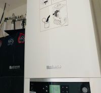 Buderus boiler with a digital display in the utility room of a family house.