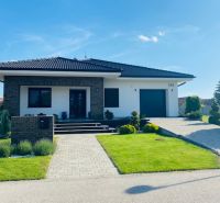 A family house on Jasná Street in Veľké Dvorníky, with a well-maintained garden and a garage.