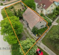A family house in Lehnice with a large plot, surrounded by greenery and trees.