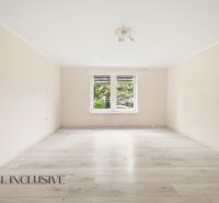A spacious room with a wooden decor floor in a family house.