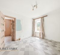 A room with dull curtains and doors, and a checkered pattern floor in a family house.