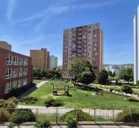 Sídlisko Ťahanovce, Belehradská: Apartment buildings surrounded by greenery and a playground in a sunny setting.