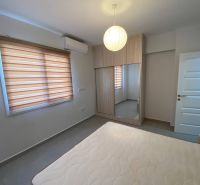 A bedroom in a 3-room apartment with a large mirrored wardrobe and curtains.