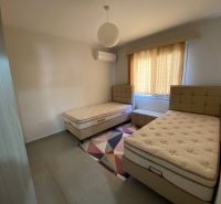 Children's room with two beds, a carpet, and curtains in a 3-room apartment.