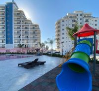 Playground and swimming pool near residential buildings in the city of Iskele.
