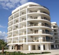 A building in Iskele with balconies, serving as apartments including 2-bedroom flats.