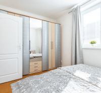 A bright bedroom in a 3-room apartment with a built-in wardrobe and a large window.