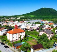 Veľký Šariš, Matice Slovenskej Street with a view of the hills and a residential area.