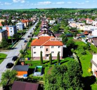 Aerial view of Matica slovenská in Veľký Šariš with a 2-room apartment in the foreground.