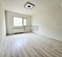 A room with a window and a radiator, a floor with a wooden decor in a 2-room apartment.