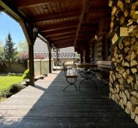 A family house with a wooden terrace and a supply of wood in Devínske Jazero, Bratislava.