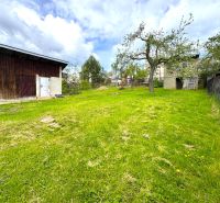 A garden plot for living in Lipany with a wooden shed and a grassy area.