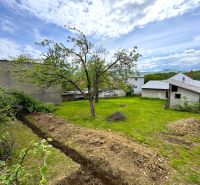 Land in Lipany suitable for living with fruit trees and a farm building.