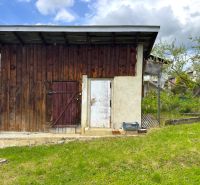A wooden farm building on a plot in Lipany designated for living.