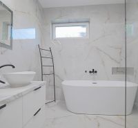 Bathroom with a freestanding bathtub and double sink in a family house.