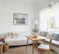A bright living room with stylish accessories in a family house, cozy seating by the window.