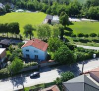 A family house on Zátoňská Street in Malinovo, surrounded by greenery and close to a sports facility.