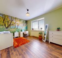 Children's room in a family house with natural wallpaper and a wooden decor floor.
