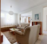 Living room in a 3-room apartment with a beige sofa and a wooden decor floor.