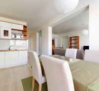 A kitchen with a dining area and a wooden decor floor in a 3-room apartment.