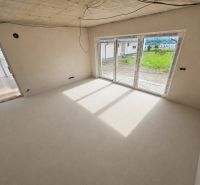 A bright room with large windows and an unfinished ceiling in a 5 or more room apartment.