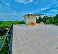 Spacious terrace of the Villa in Bali with a view of the green rice fields.