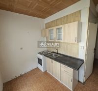Kitchen corner with a gas stove in a studio apartment and a floor with a wooden decor.