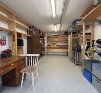 Workshop with a table, shelves, and a bicycle in a 3-room apartment.