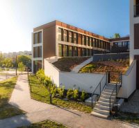 A building with a green roof and staircase on Mierová Street in Bratislava - Ružinov.