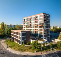 The building on Mierová Street in Bratislava - Ružinov, surrounded by greenery and situated by the road.