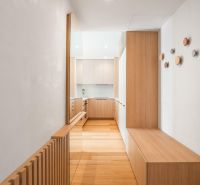 Interior of a 3-room apartment with a wooden decor floor and built-in wardrobes.