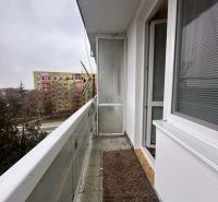 A balcony with a carpet mat in the Recreational Apartment Dunajská Streda, view of the housing estate.