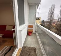 Balcony of a holiday apartment with a view of trees in Dunajská Streda.