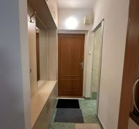 Entrance hallway in a holiday apartment with built-in wardrobes and coat racks.