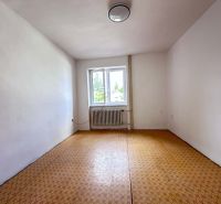 A spacious bright room with a window, wooden decor flooring, family house.