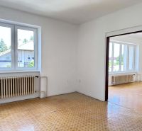 Interior of a family house with white walls and a wooden decor floor.