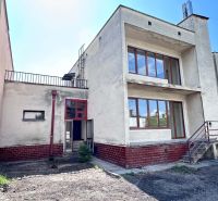 A family house in Dunajská Streda with a modernist design, red elements, and glass doors.