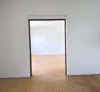 Two empty rooms in a family house with wooden decor floors.