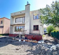 A family house in Dunajská Streda with a garden and strong sunlight.