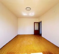 The interior of a room in a family house with a yellow decor floor and white walls.