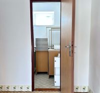 Opening door leading to a bathroom with tiled floor in a family house.