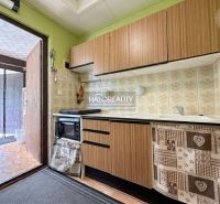 A kitchen in a cabin with wooden decor and a vintage kitchen unit.