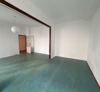 A bright room with a colorful floor and white walls in a 3-room apartment.